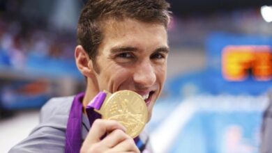 Michael Phelps of the U.S. poses with his gold medal after winning the men's 4x100m medley relay final during the London 2012 Olympic Games at the Aquatics Centre